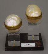 A pair of Paris mounted mother-of-pearl shell boxes on stand.