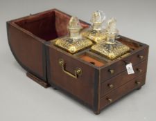 A 19th century mahogany decanter box fitted with three gilt heightened decanters. 26 cm high.
