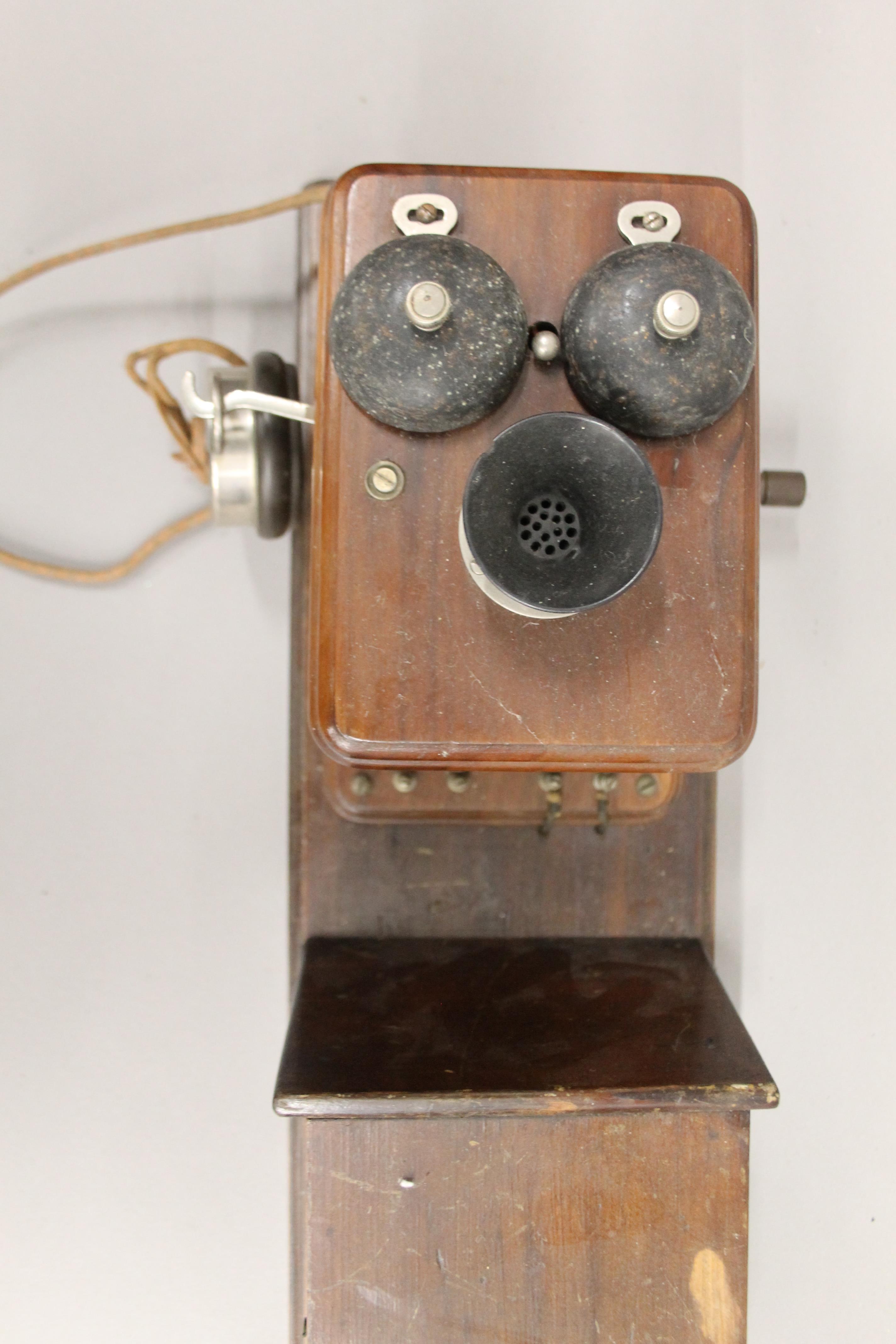 A vintage wooden wall mounted telephone. - Image 3 of 5