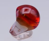 A Lalique amber coloured ring, the shank inscribed Lalique R France. Ring size O/P.