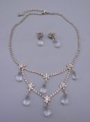 A crystal drop necklace with matching earrings. Necklace 46 cm long, earrings 3 cm high.