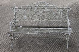 A wrought iron and wood garden seat.