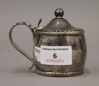 A Georgian silver oval mustard pot, Birmingham 1823. 8 cm high. 4.3 troy ounces.