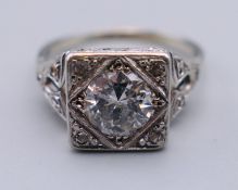 A platinum and diamond ring, the central stone spreading to approximately 0.75 of a carat.