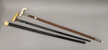 Three late 19th/early 20th century ivory handled walking sticks. The longest 94 cm.