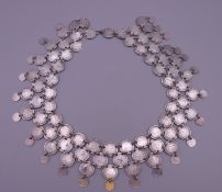 A Persian silver coin dowry necklace. Approximately 41 cm long. 46.6 grammes.