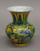 A Chinese porcelain yellow ground vase decorated with figures. 12.5 cm high.