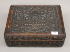 A large Chinese hardwood box and cover, both intricately carved with lotus flowers. 36 cm wide.