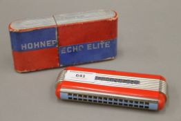 A Hohner Echo Elite mouth organ, boxed.