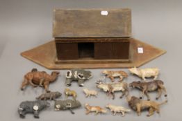 A wooden model ark and a quantity of various animals. The ark 61 cm long.