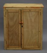A vintage pine two door cupboard. 81.5 cm wide.