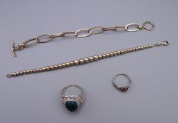 Two silver bracelets and two silver rings. Bracelets approximately 19 cm long. 26.