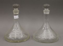 A pair of etched glass ships decanters. 24 cm high.