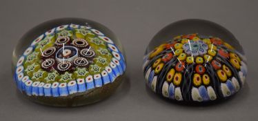 Two millefiori glass paperweights. The largest 5 cm high.