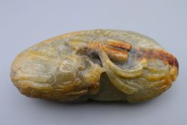 A jade pebble carving in the form of a dragon. 10.5 cm x 5 cm.