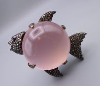 A silver, diamond and rose quartz fish form brooch. 5 cm long x 4.5 cm high.