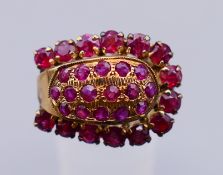 A 14 K gold and ruby horseshoe form ring. Ring size M.