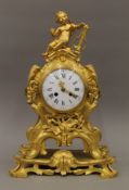 A gilt bronze clock with putto finial. 48 cm high.