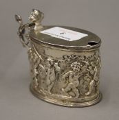 An embossed silver mustard pot, lacking liner. 7 cm high. 3.6 troy ounces.