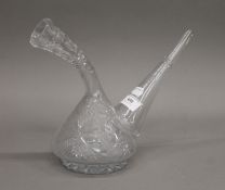 An unusual cut glass carafe etched with vine leaves, etc. 24 cm high.