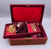 A vintage jewellery box and contents including watch parts.