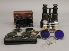 A box of binoculars and spectacles, one pair of binoculars by Harrods Ltd.