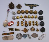 A tin of military buttons and badges.