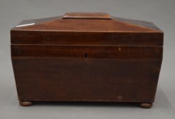 A 19th century mahogany tea caddy. 30.5 cm wide.