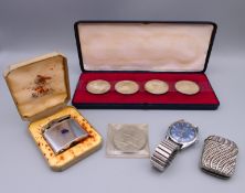 A vesta, a Ronson lighter, an Avia wristwatch, four Austrian coins and a 1977 Jubilee coin.
