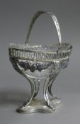 A crystal lined Continental silver sugar basket. 14 cm long.