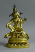 A gilt bronze model of Buddha seated above a dog-of-fo. 29.5 cm high.