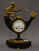 A 19th century bronze mantle clock formed as a classical woman emerging from an oil lamp. 37.