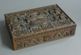 An Eastern box carved with a dragon. 30 cm wide.