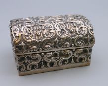 A Continental silver domed casket form box. 6 cm wide, 4 cm high, 4 cm deep. 55.
