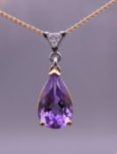 An 18 ct gold, amethyst and trillion cut diamond pendant on an 18 ct gold chain.