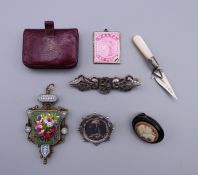 A quantity of Victorian brooches, a purse, a micro-mosaic pendant, a miniature silver trowel, etc.