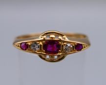 An 18 ct gold, ruby and diamond ring. Ring size S.
