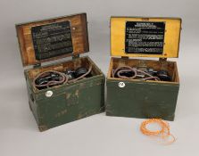 Two boxed War Department field telephones.