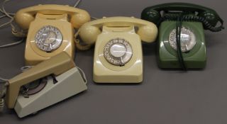 A box of various vintage telephones.