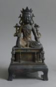 A bronze figure of buddha with calligraphy. 24 cm high.