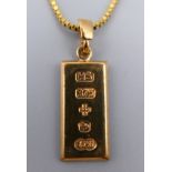 A 9 ct gold ingot on a 9 ct gold chain. Ingot 2 cm x 1 cm, chain 42 cm long. 6.4 grammes.