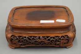 A Chinese carved wooden stand. 19 cm wide.