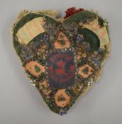 A vintage heart shaped pin cushion. 18 cm wide.