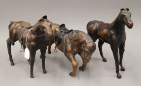 Three leather models of horses. The largest 32 cm high.