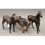 Three leather models of horses. The largest 32 cm high.