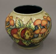 A Moorcroft Pastimes vase. 10 cm high.