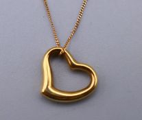 A 9 ct gold heart shaped pendant on a 9 ct gold fine chain. Pendant 1 cm x 1 cm. 0.4 grammes.