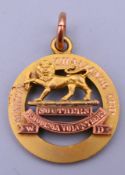 A 9 ct gold Martin Challenge Cup Southern Rhodesia Volunteers medallion. 2.5 cm diameter. 6.