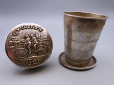 A tapered collapsible beaker, the lid embossed Cyclist's Cup' and depicting two cyclists,
