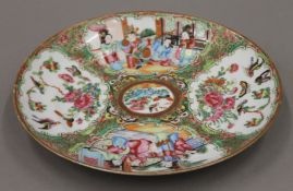 A 19th century Canton famille rose porcelain plate hand painted with attendants, birds, butterflies,